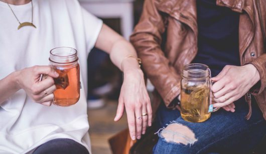 two people drinking tea together