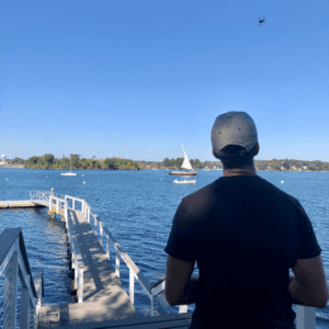 Man flying drone over the water