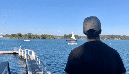 Man flying drone over the water