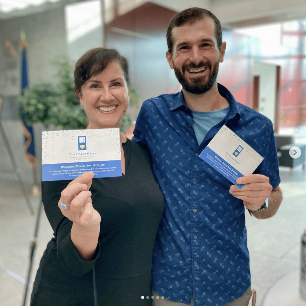 DARCI staffers holding a postcard with the new Chase Home logo that DARCI Creative designed